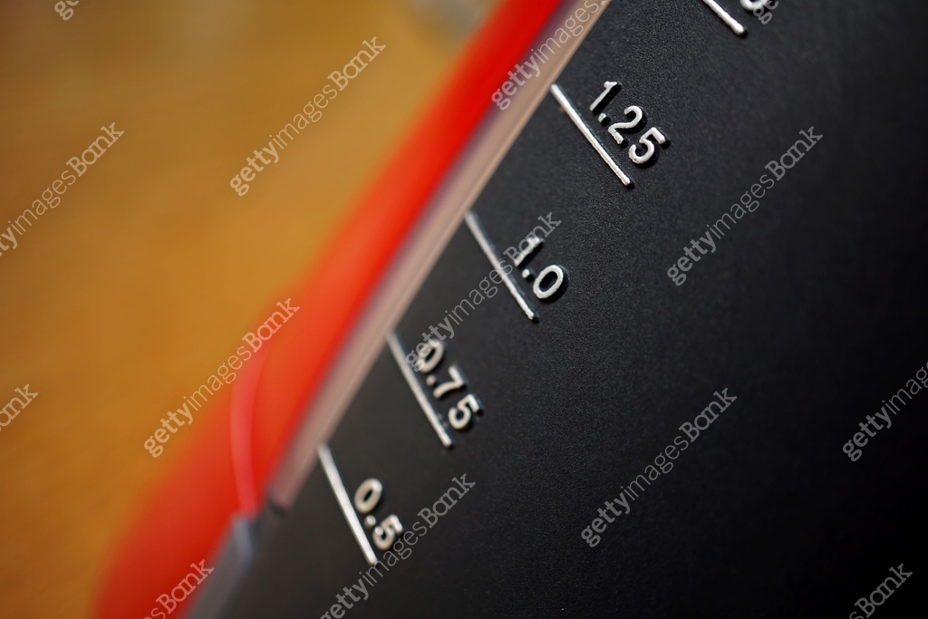 Silver scale measuring volume of liquid (displaying units in liters ...