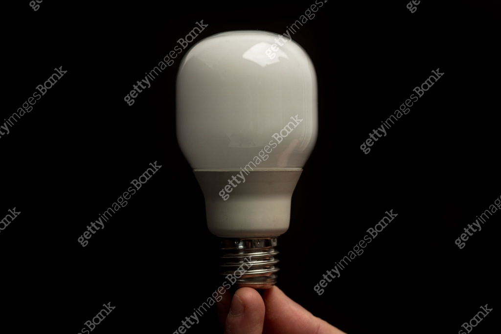 Man holding economic light bulb in his fingertips close up 이미지 ...
