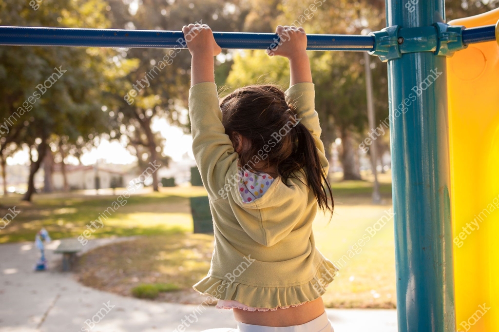 Little Girl Hanging From Monkeybar In Playground 871074128 little-girl-hanging-from-monkeybar-in-playground-871074128