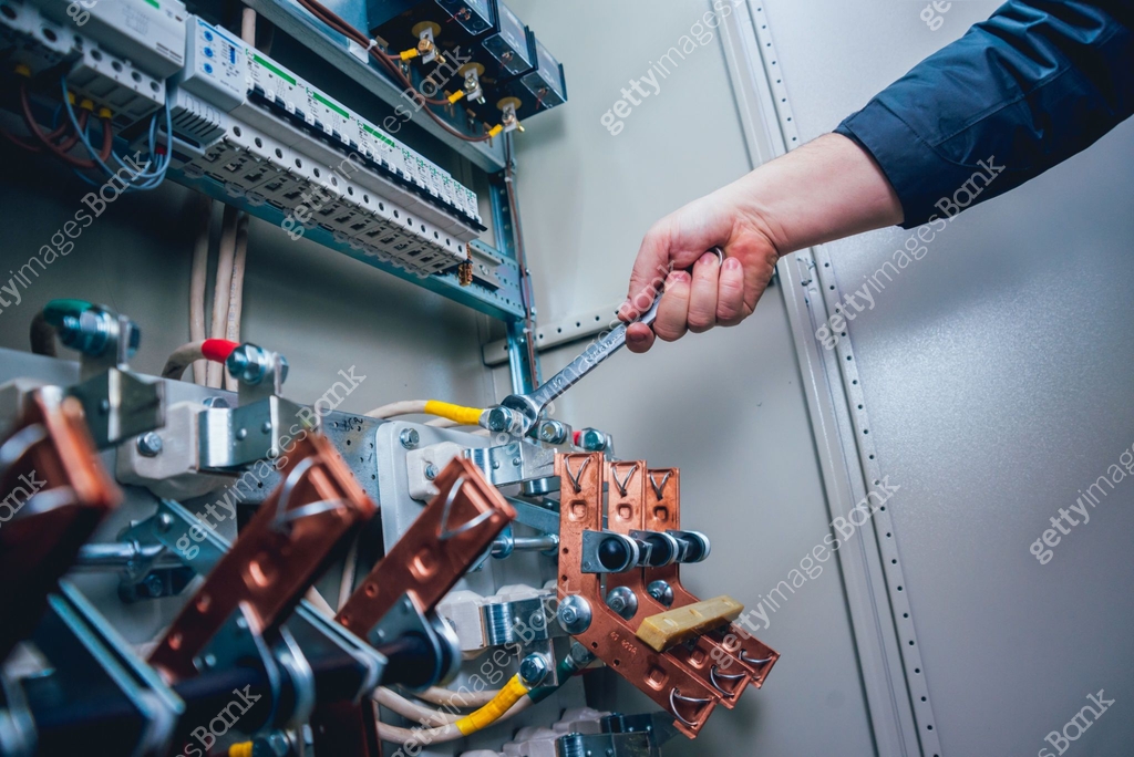 Testing Electrical Switch Electricians hands testing switches in electric box. Electrical panel ...