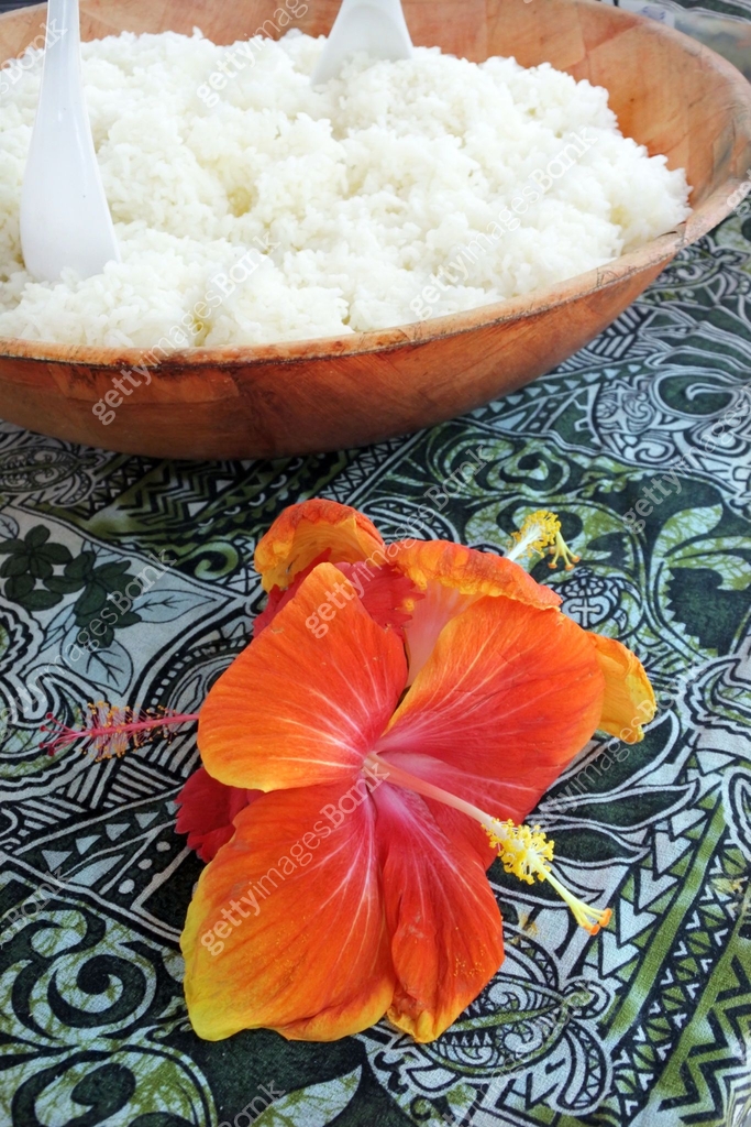Bowl of rice served with red hibiscus flower decoration in Rarotonga ...