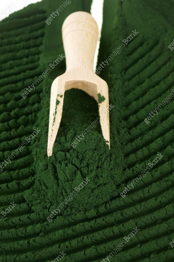 Spirulina powder.Algae spirulina.green dry powder algae in a wooden ...
