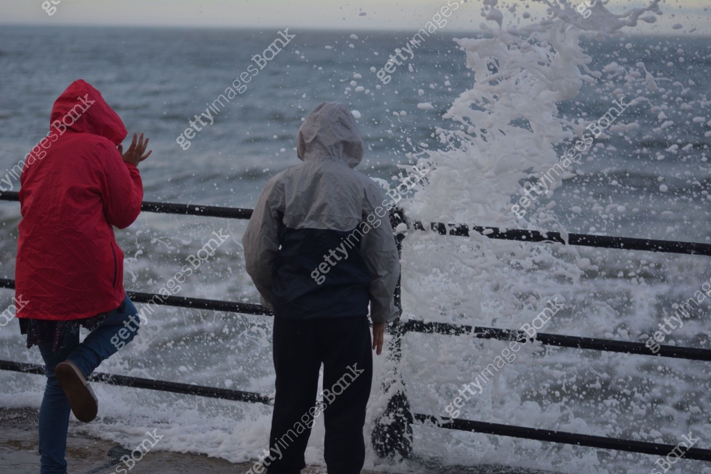 Young children getting splashed on the seaside promenade at Scarborough ...