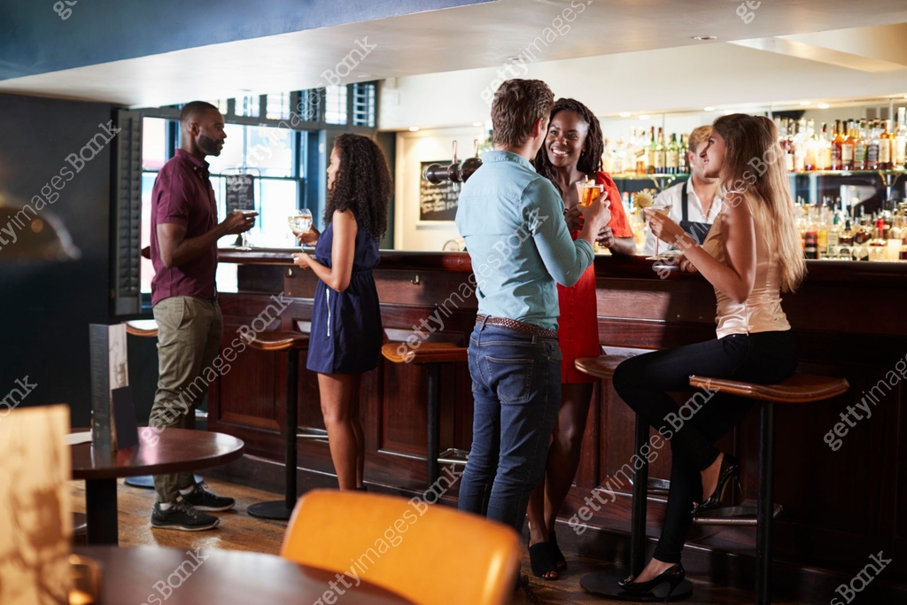 Group Of Young Friends Relaxing In Bar Standing At Counter 이미지 ...