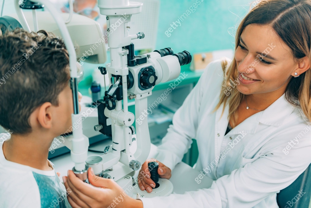Eye Exam. Ophthalmology, slit lamp exam, school boy having his eye
