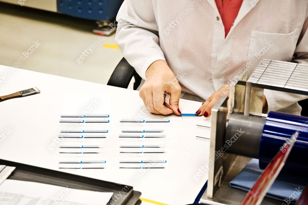 Female Engineer (Woman Scientist) Examines a Electronic Sensors In The ...