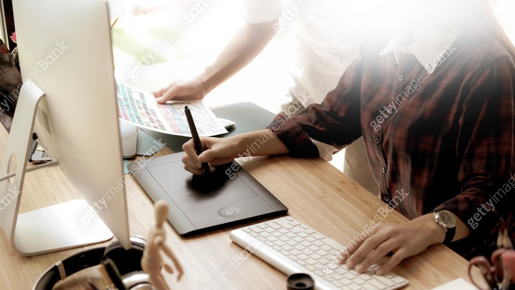 Young female designer drawing sketches on digital graphic draw tablet ...