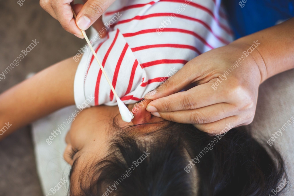 Parent helping her child perform first aid ear injury after she has ...