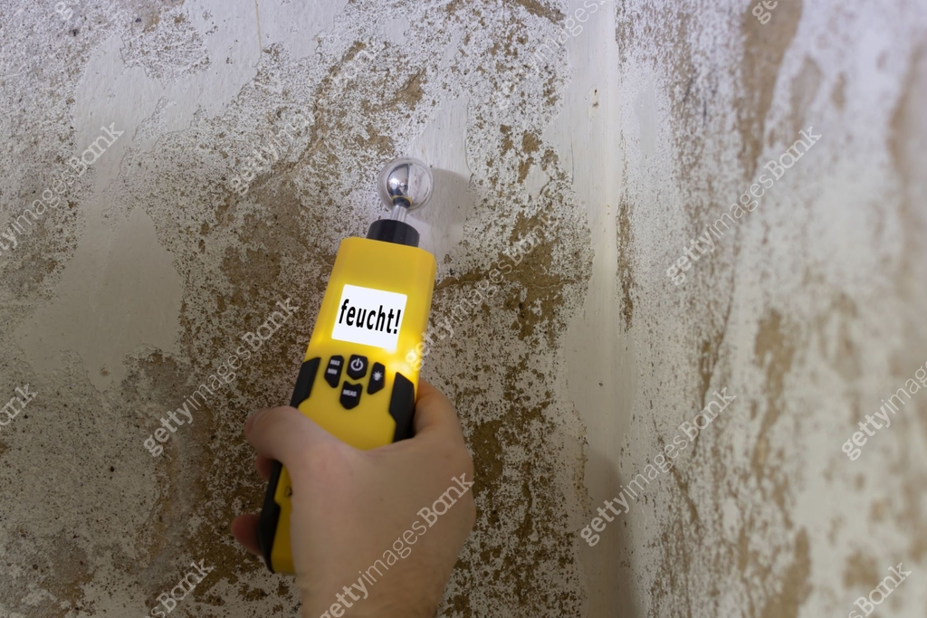 Humidity is measured at a wall in the basement. Instrument indicates a ...