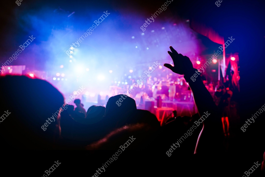 Concert Hand Ribbon silhouettes of hand in concert.Light from the stage.confetti.the crowd ...