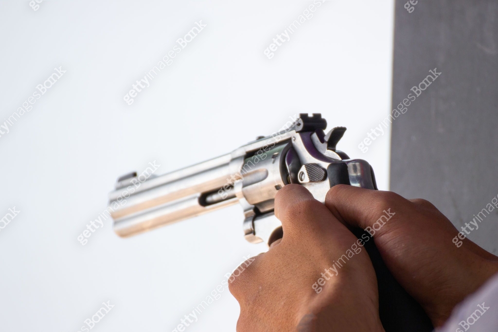 Man Hold A Gun Ready To Shoot Practicing Shooting 1125797551 man-hold-a-gun-ready-to-shoot-practicing-shooting-1125797551
