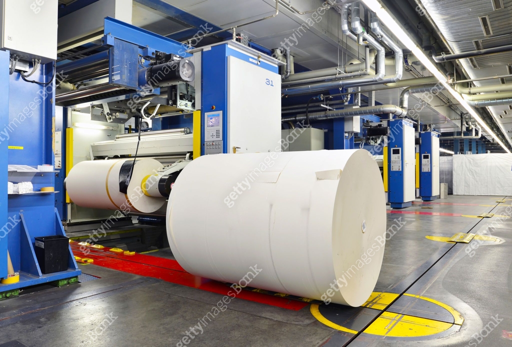 Machine Shooting Paper paper rolls and offset printing machines in a large print shop for ...