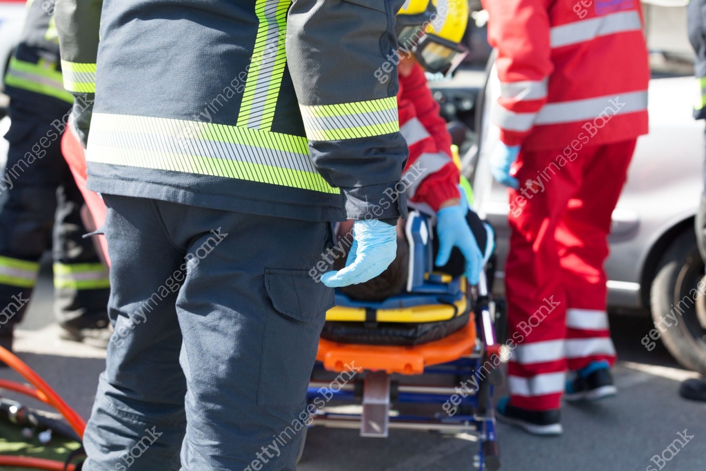 Road Rescure Paramedics and firefighters in a rescue operation after road traffic ...