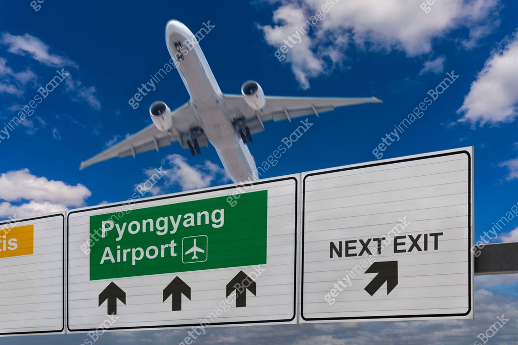 Pyongyang Highway Sign Road sign indicating the direction of Pyongyang airport and a plane ...