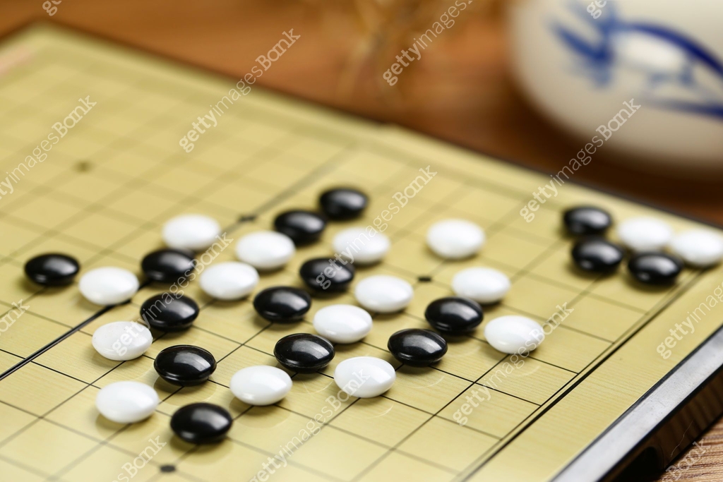 Chinese go game board, close up view of playing black and white stone ...