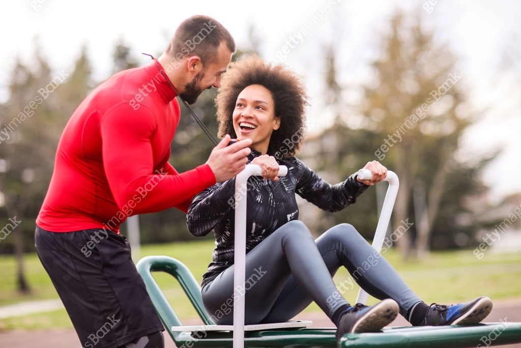 Buff personal coach encouraging an afro-american female athlete and ...