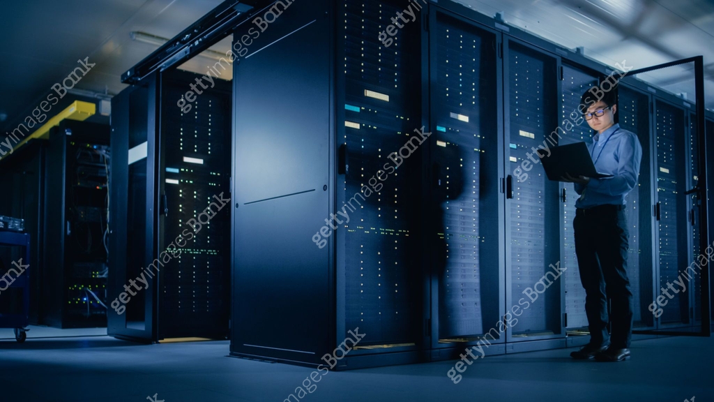 In Data Center: Male IT Technician Running Maintenance Programme on a ...