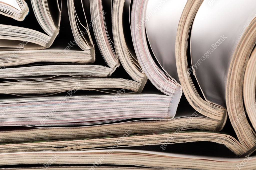 selective focus of the stacking magazine place on white background ...