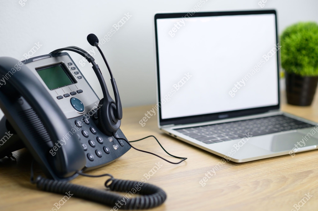 Office work space of IP Telephone with headset and laptop computer on ...