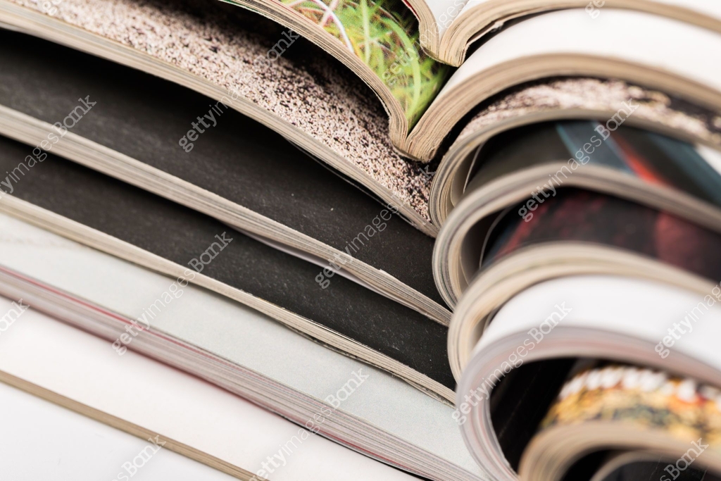 selective focus of the stacking magazine place on white background ...