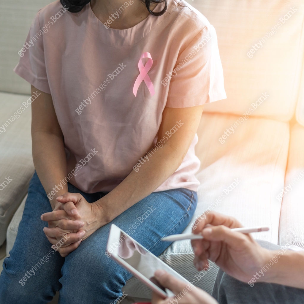 Breast cancer pink awareness ribbon on woman patient consulting with ...