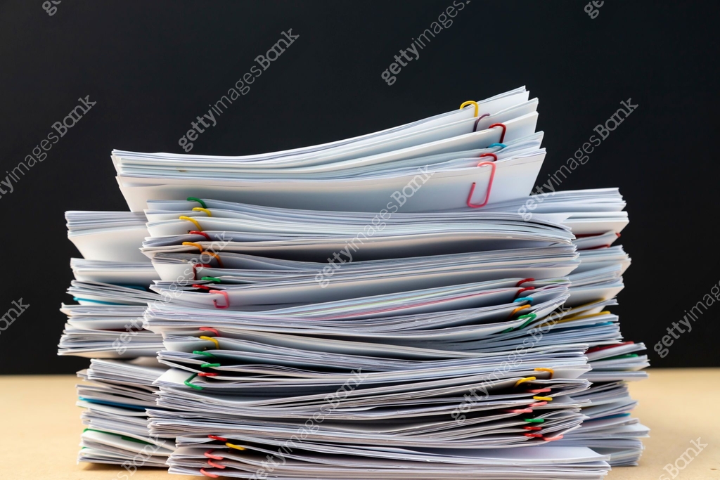 Stack of document paper with colorful paperclip place on wooden table ...