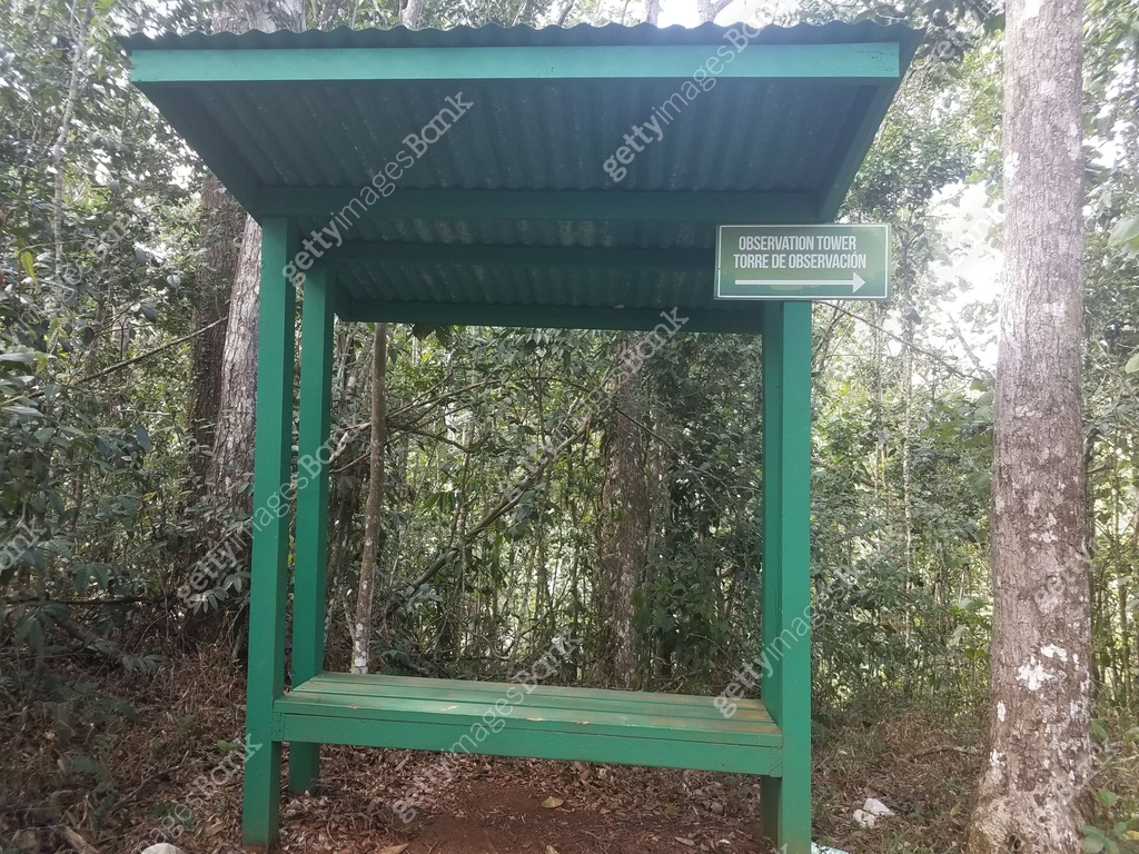 Puerto Rican Level Bench green bench with shelter and sign to observation tower in the Guajataca ...
