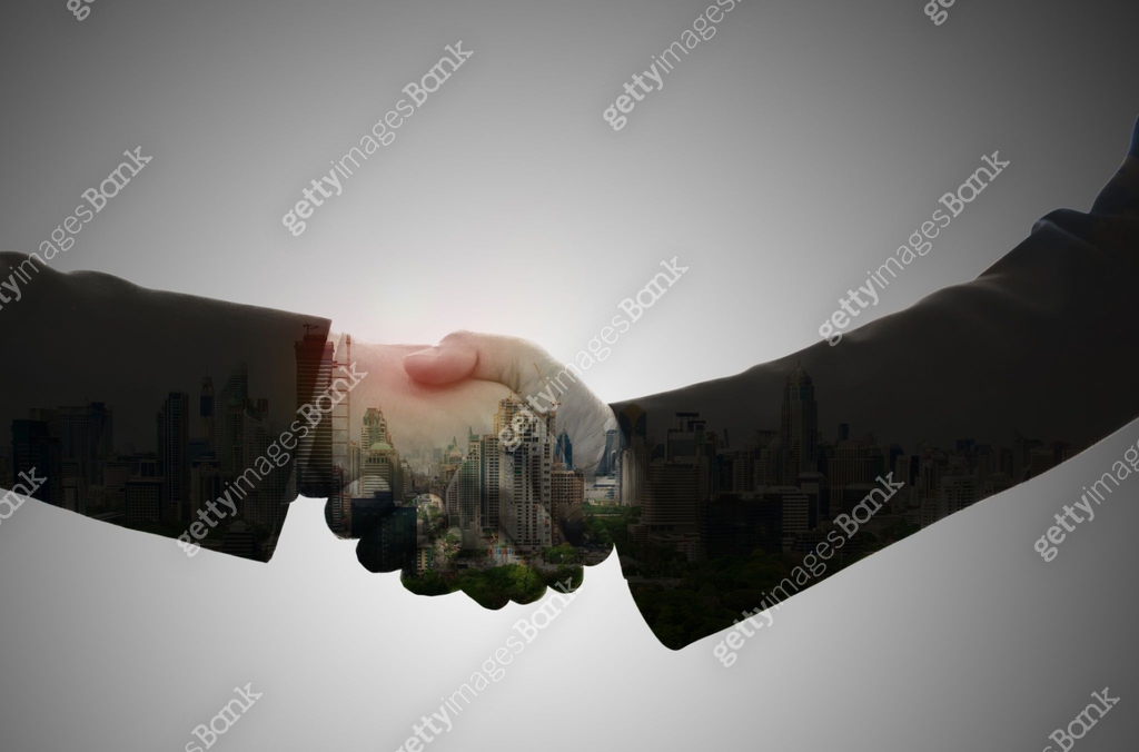 Partners Abstract Double exposure of business handshake on abstract city background ...