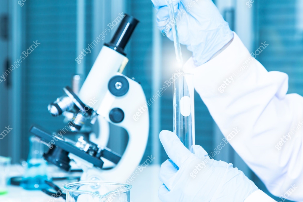 Closed up Research Scientist conducting experiment by Micropipette ...