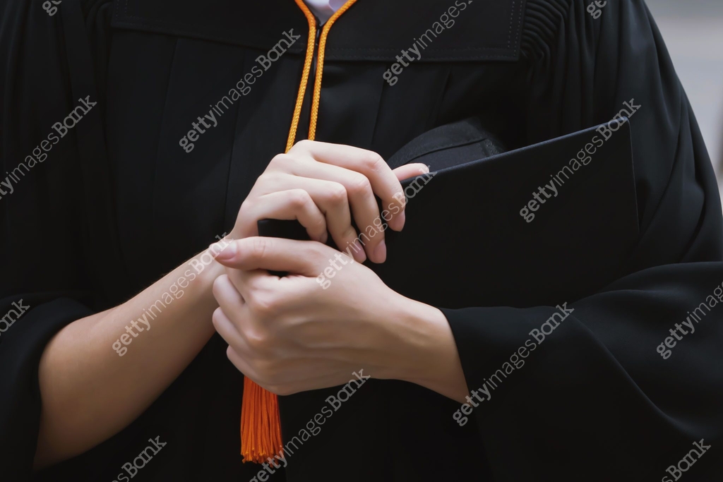 Graduation Hand graduation,close up student holding hats and tassel Orange in hand ...
