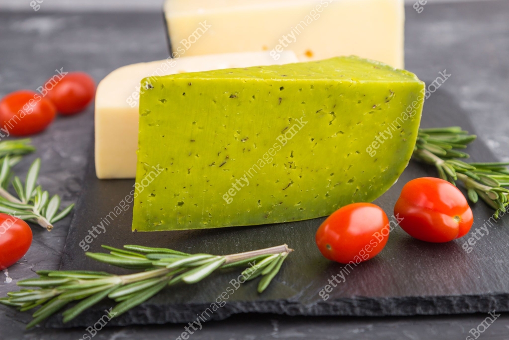 Green basil cheese and various types of cheese with rosemary and ...