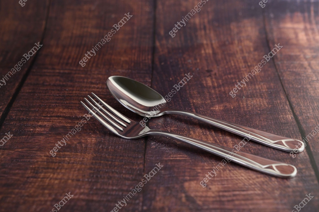 Rustic Table Fork Sparkle stainless fork and spoon placed on the wooden table with rustic ...