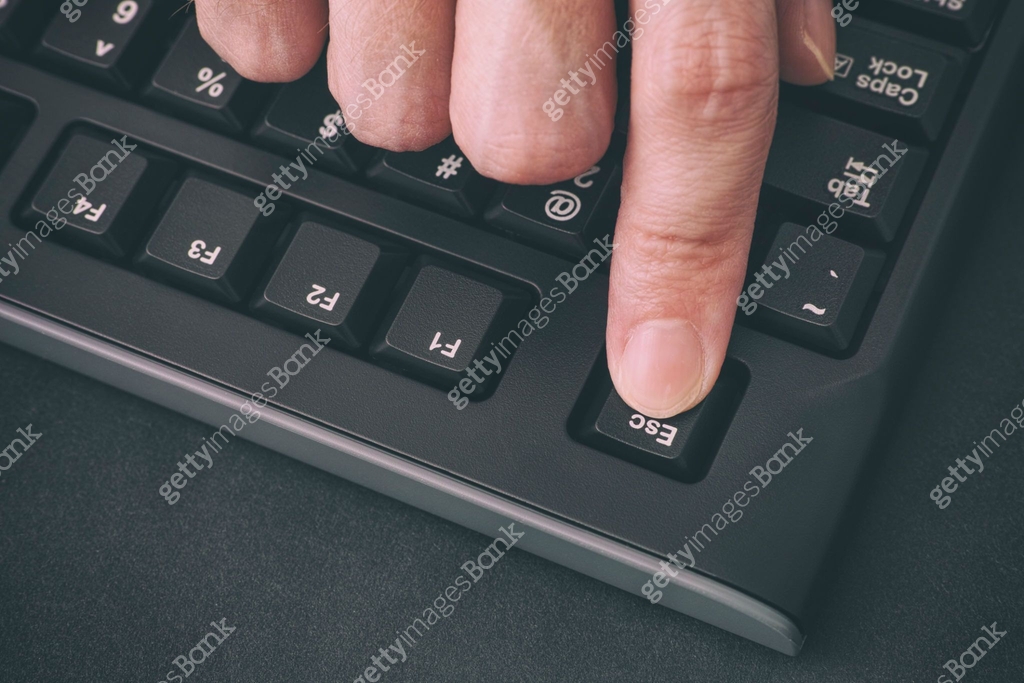 Computer Key Finger Person's finger pressing Escape key on a black computer keyboard 이미지 ...