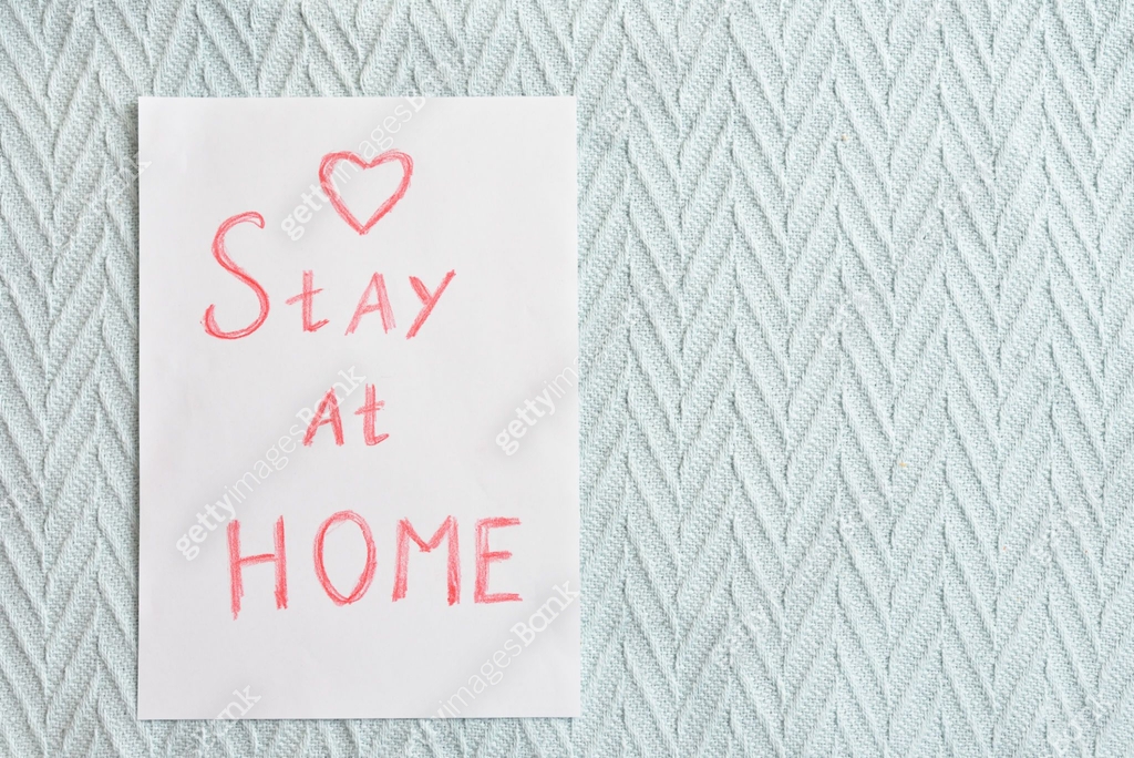 Stay at home - an inscription on a paper sheet against the background ...