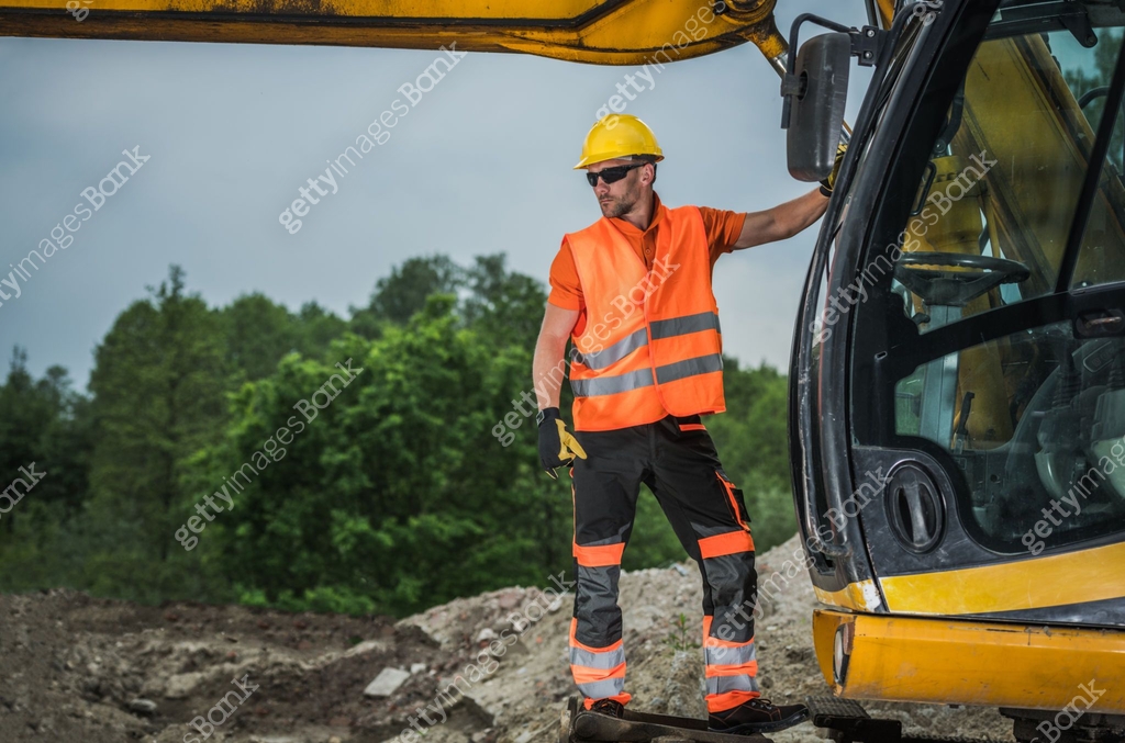 Machine Operator Standing On Hydraulic Excavator Assessing Job Site ...
