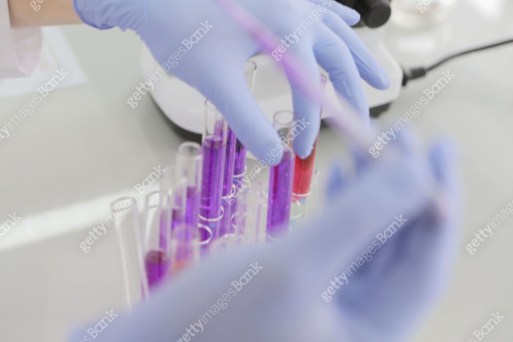 Young female Laboratory scientist working at lab with test tubes and ...