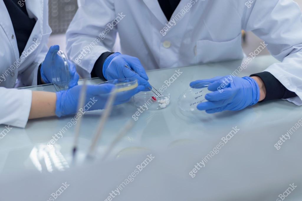 Group of Laboratory scientists working at lab with test tubes, test or ...