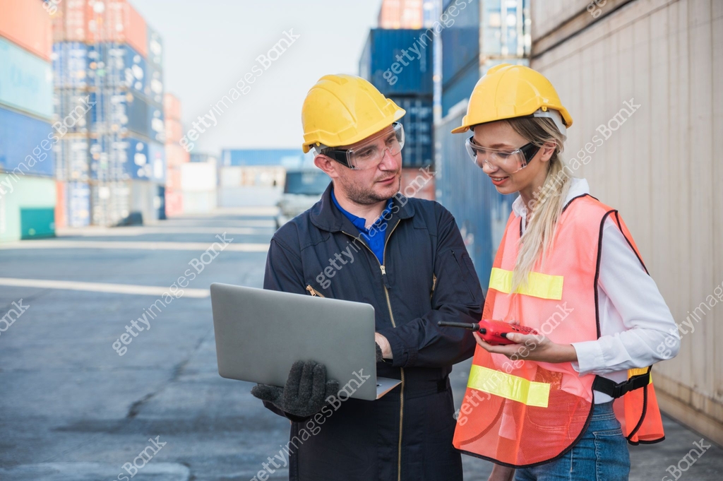 Two foreman man & woman worker working checking at Container cargo ...