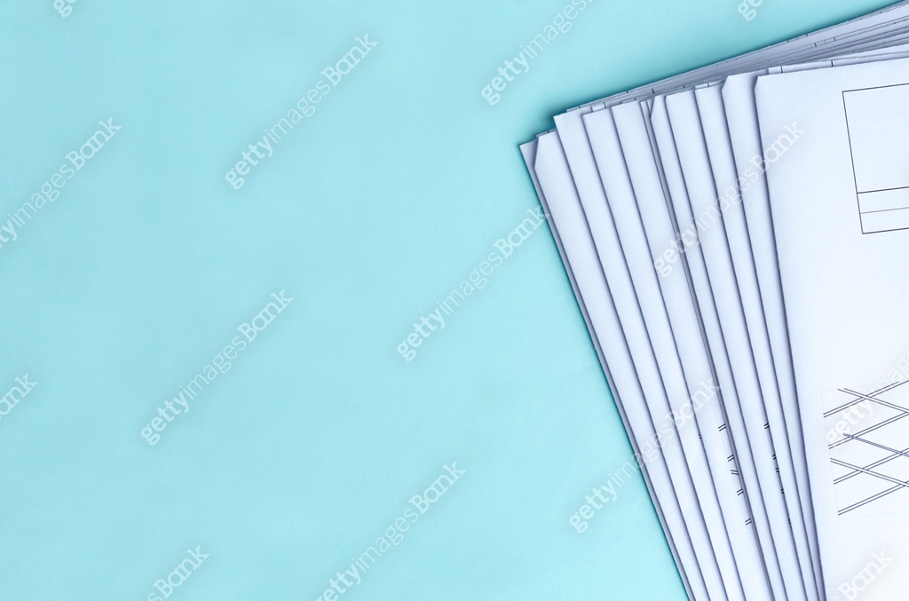 Stack Folding drawings on a blue background. Top view. Flat lay. Copy ...