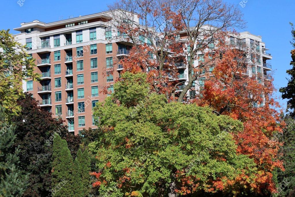 Large apartment building surrounded by trees in fall colors 이미지 ...