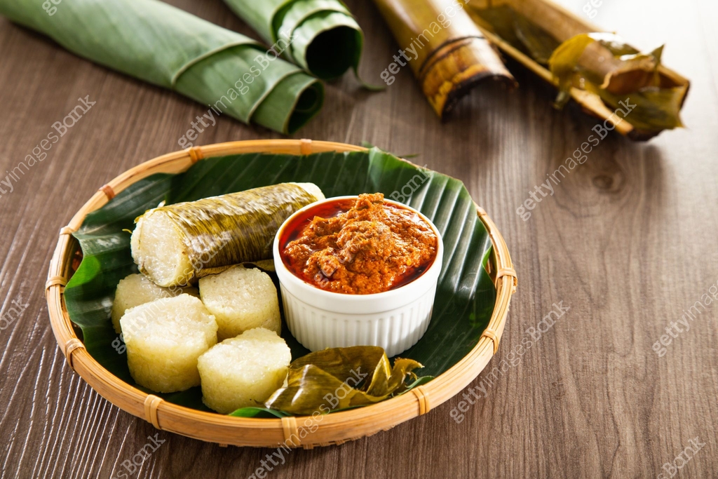 Lerek Sapi Lemang. Glutinous rice is wrapped with lerek or banana leaf encased in ...