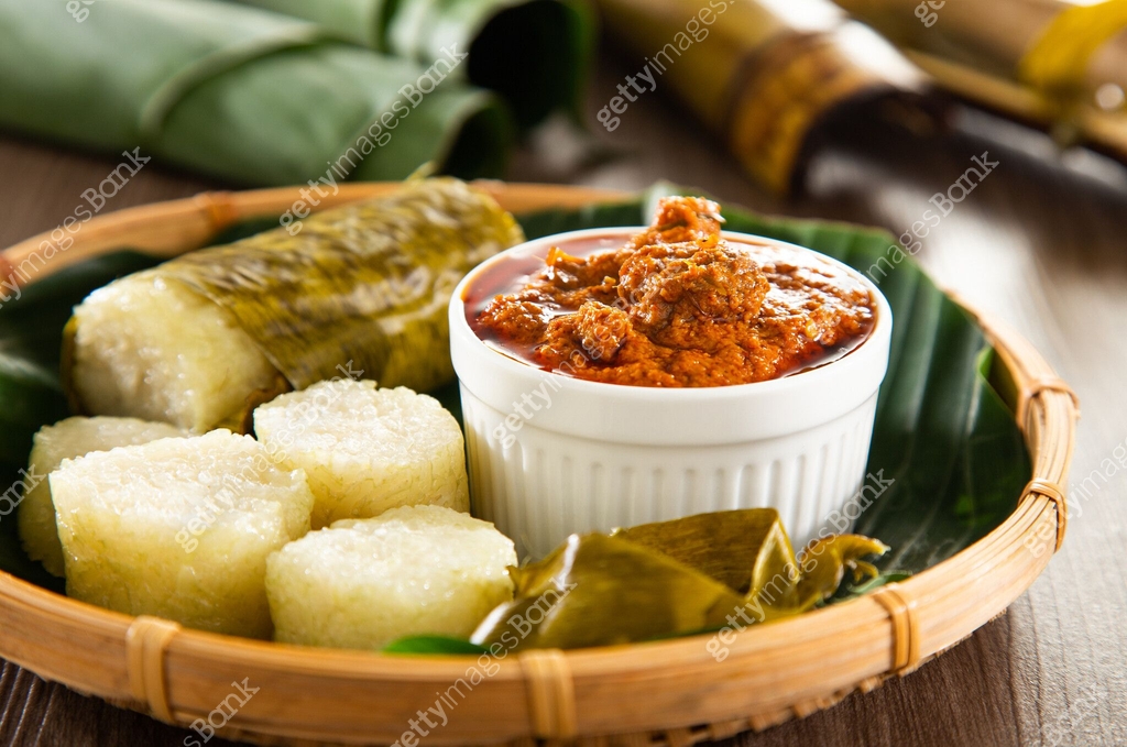 Lerek Sapi Lemang. Glutinous rice is wrapped with lerek or banana leaf encased in ...