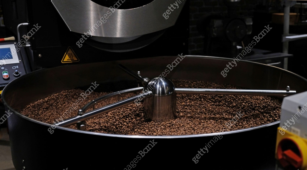 Coffee roaster machine at coffee roasting process. Mixing coffee beans ...