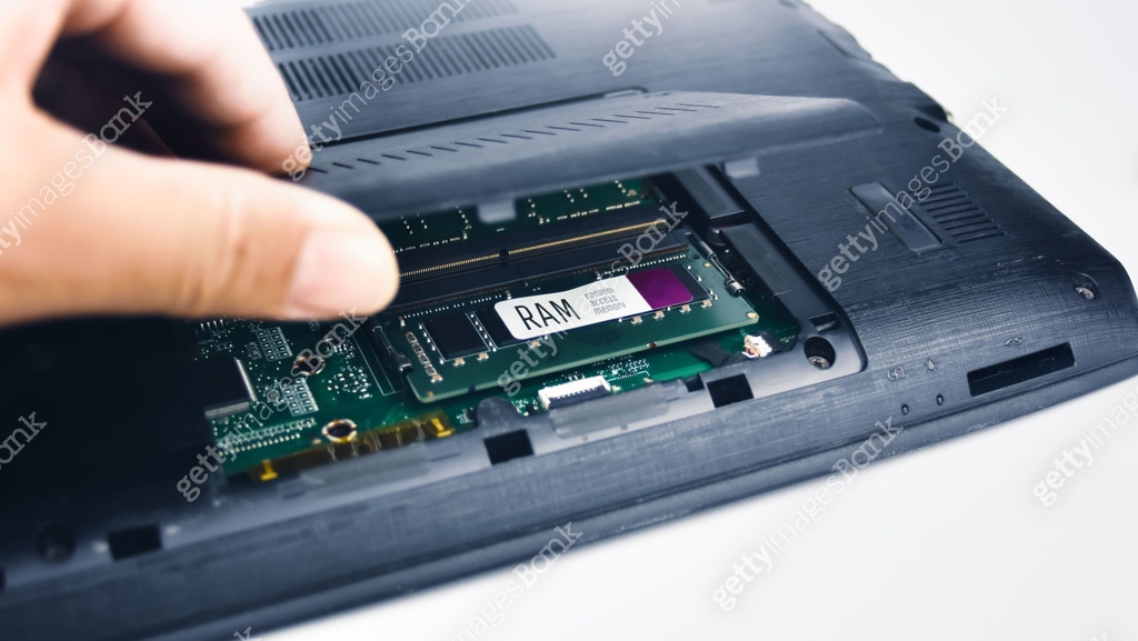 Computer Openning Technician inspects the RAM of a laptop computer by opening the lid 이미지 ...