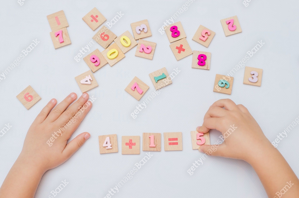 Child Using Numbers Five year old child learn learns arithmetic using a set of wooden ...