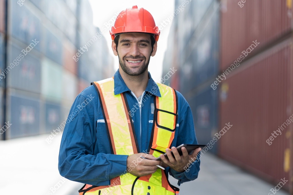 Portrait of foreman container yard worker loading containers box with ...