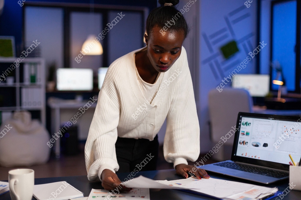 Concentrated overworked african american businesswoman analyzing ...