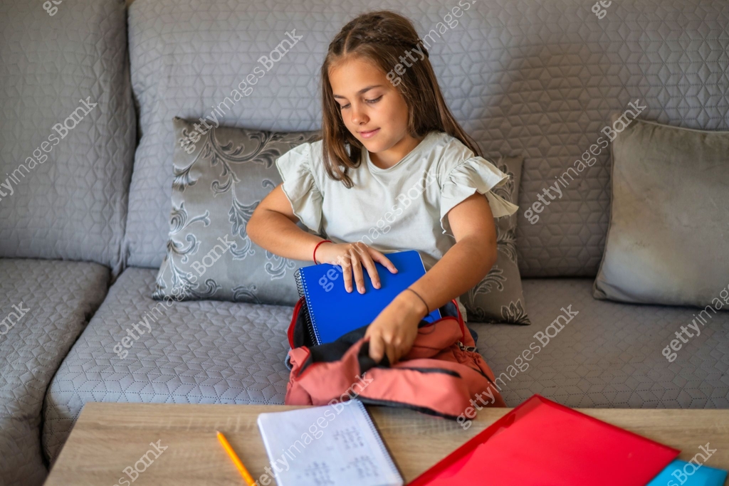 Primary School Age Girl Collecting School Supplies In Her Backpack ...