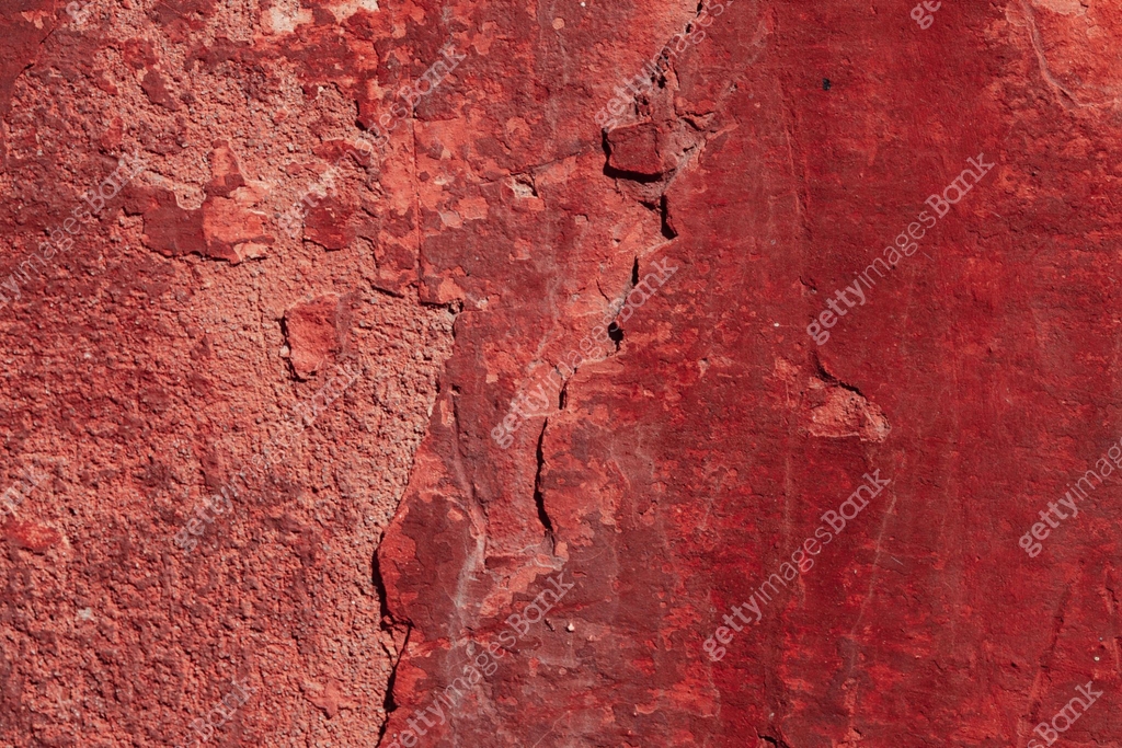 Red concrete wall with deep scratches and chips. Various variations of ...