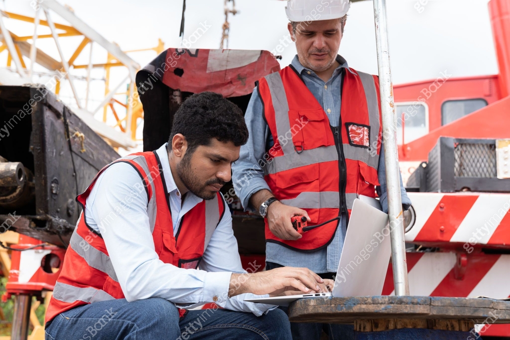 Teamwork of male engineer construction discuss and working with laptop ...
